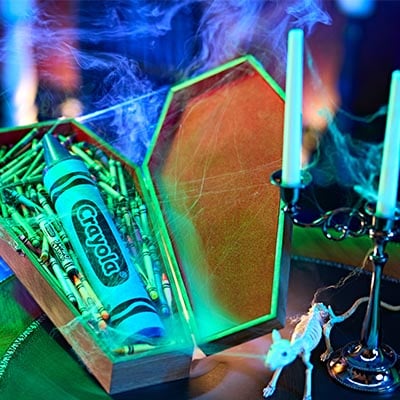 Spooky halloween coffin filled with crayons.