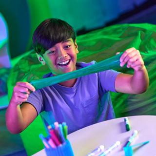 goo-inspiration-1 Young boy stretching green colored Crayola Goo
